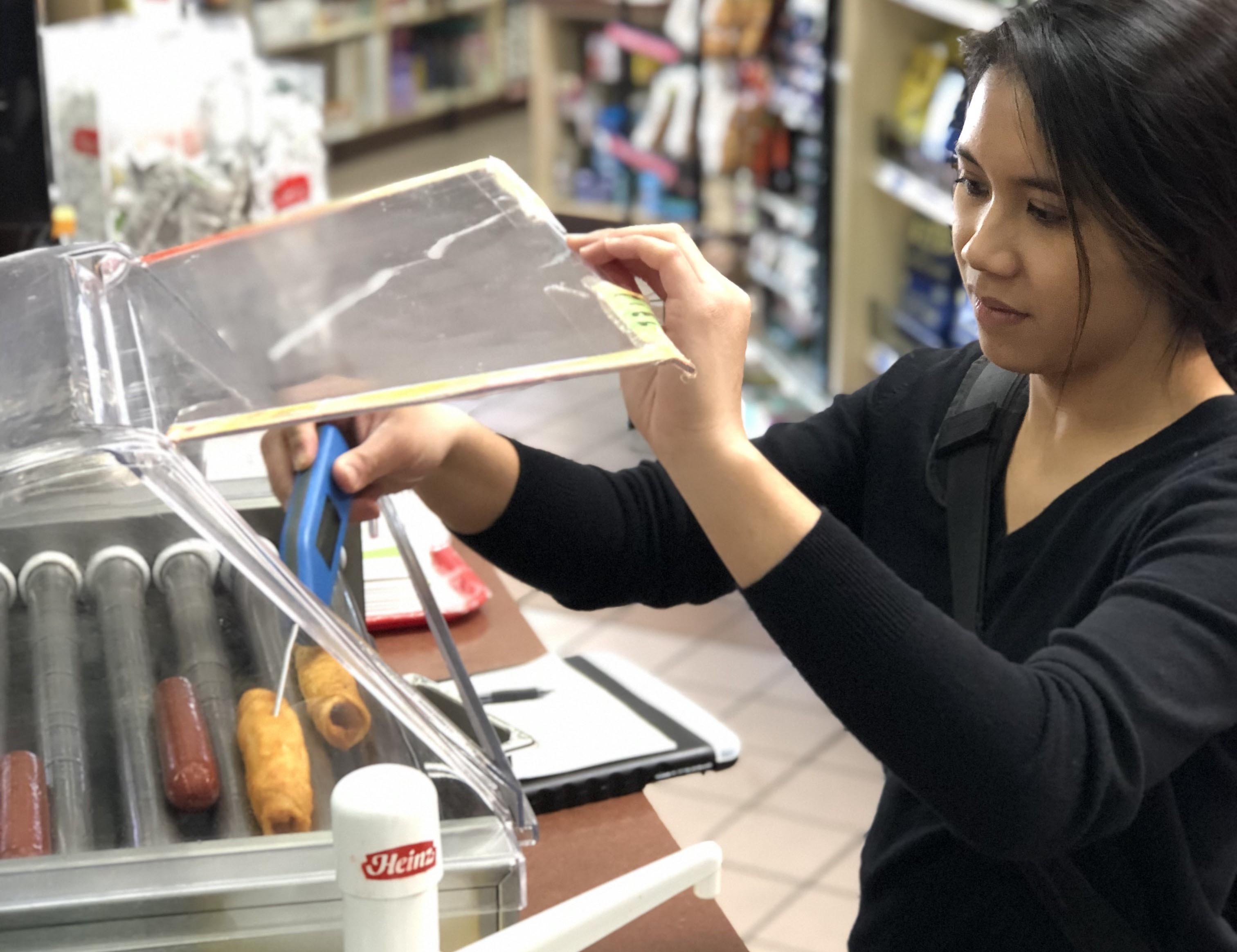Rebekah Abangan conducting a food safety survey of a tribal convenience store